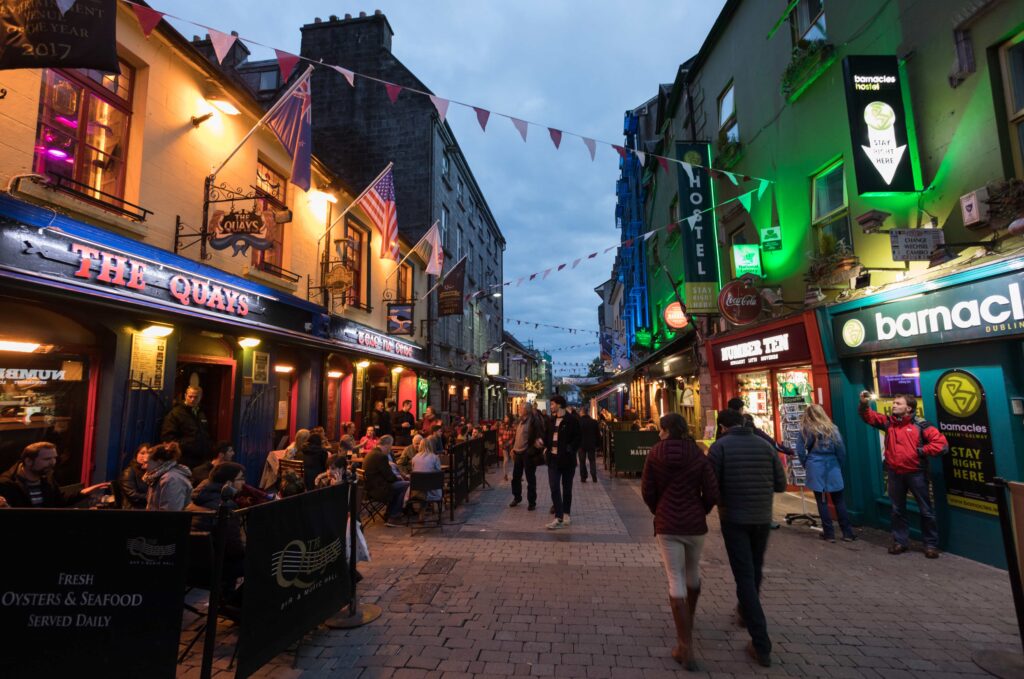 People enjoying bars and Restaurants on Quay street in the popular Latin quarter area of Galway city at night